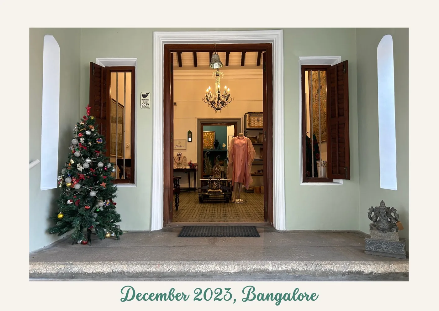 One of my postcards: the open doorway of an old Bangalore shop with a Christmas tree outside, captioned December 2023, Bangalore. Opens the 2024 edition as a PDF.